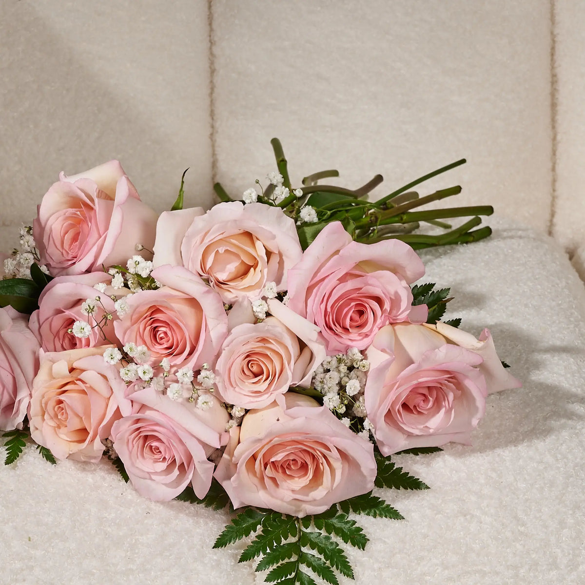 Bouquet of pink roses on a textured surface