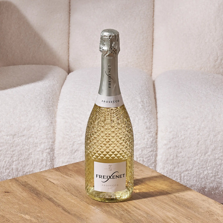 Freixenet Prosecco bottle on a wooden table with a soft, neutral background add-on gift by Gilded Blooms