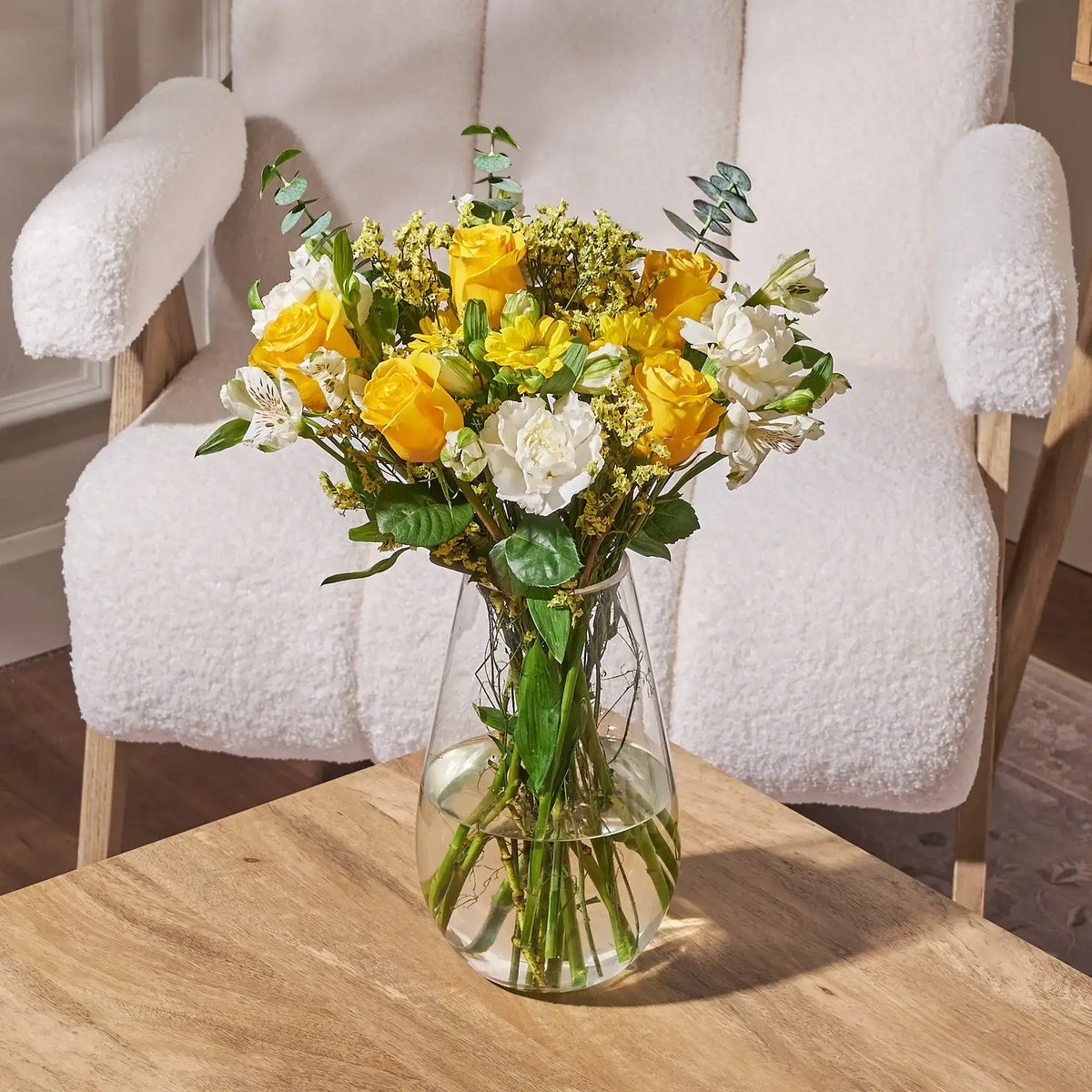 yellow rose bouquet with white carnations and greenery floral arrangement in vase