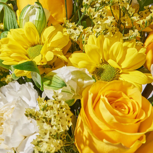 Bouquet of yellow and white flowers with green leaves