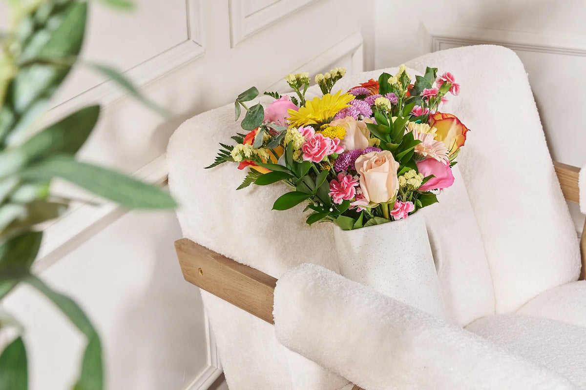 Bouquet of flowers on a white cushion with a blurred background