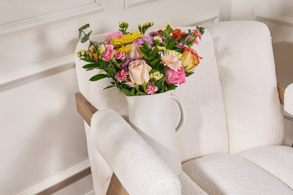 Bouquet of flowers on a white chair with a white background
