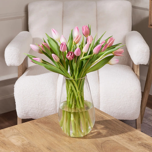 Elegant pink tulip bouquet featuring 20 fresh stems styled in a modern glass vase
